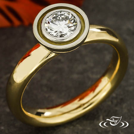 14Ky High Polish Ring With Platinum Bezel Holding A 0.40Ct D/E VS RB Diamond. 