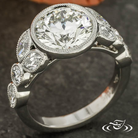  Bezel Set Center Diamond With Diamond Shapes On The Shoulder