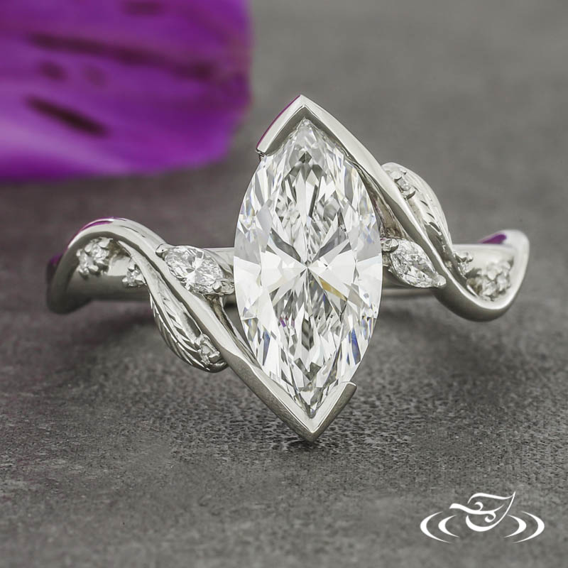 A marquise and feather engagement ring with a wrap setting and diamond accents.